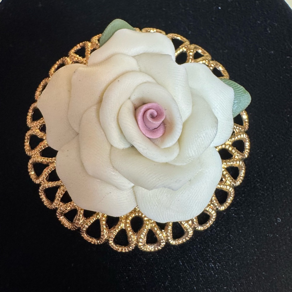 Vintage cream colored bisque rose brooch on gold tone filigree frame